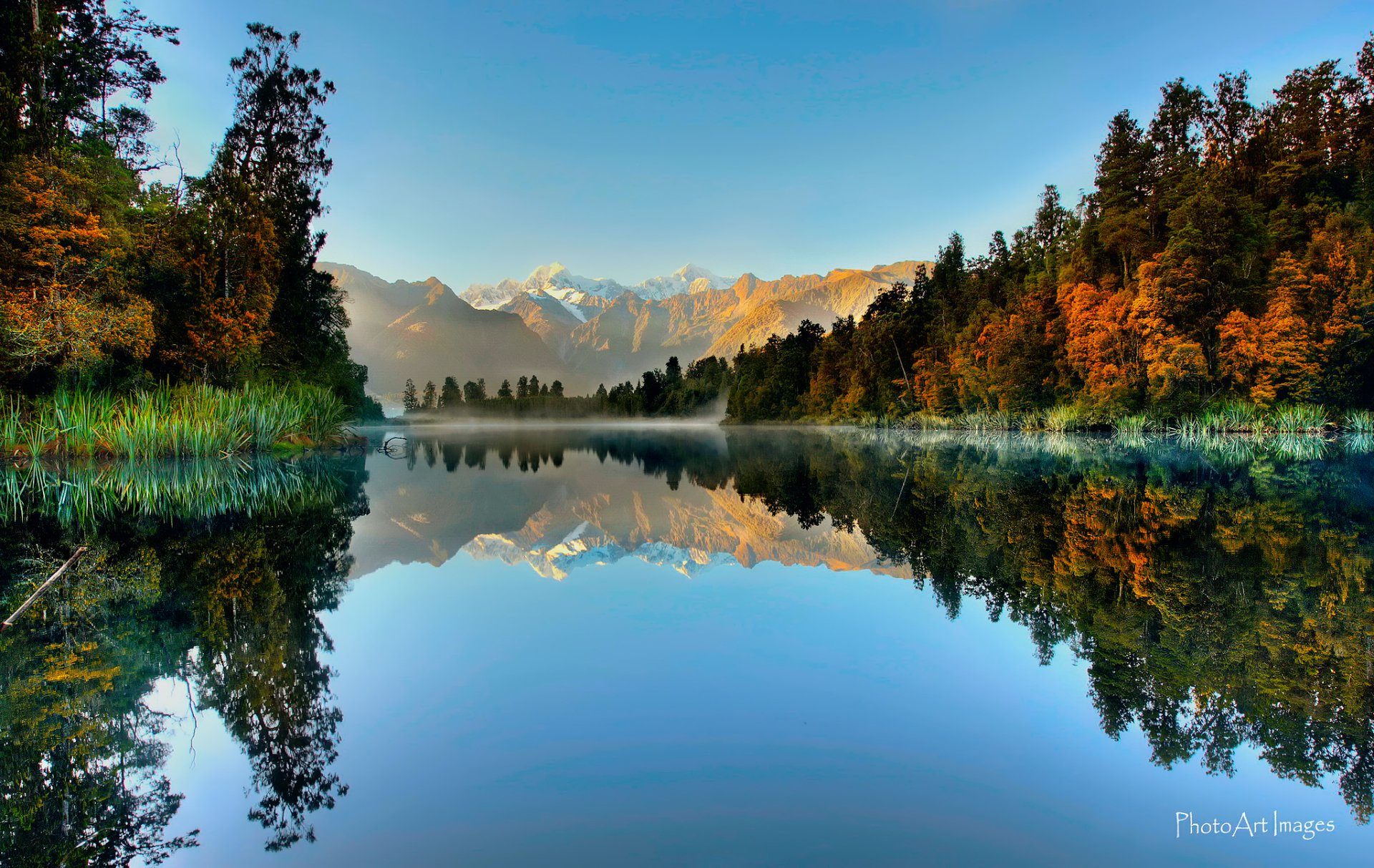 Mirror lake with mountains and forest